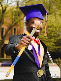 a man wearing a graduation cap and gown